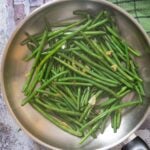 An overhead shot of a pan of just cooked Green Beans with Garlic, ready for serving.