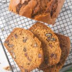 An overhead shot of slices of date and nut bread on a cooling rack.