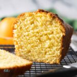 Feature image for easy orange pound cake, showing the inside to highlight the softness of the cake.