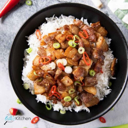 Feature image for Thin-Sliced Pork Belly Stir Fry showing it served with white rice, garnished with spring onions.