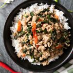 An overhead shot of ground pork stir fry served on top of white rice.