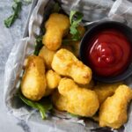 An overhead shot of air-fried frozen chicken nuggets served as an appetizer.
