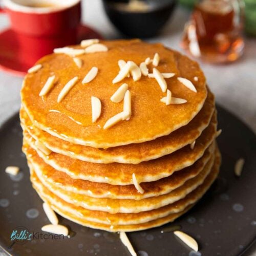 Feature image for rice flour pancakes, showing a stack of them, with almond slices on top.