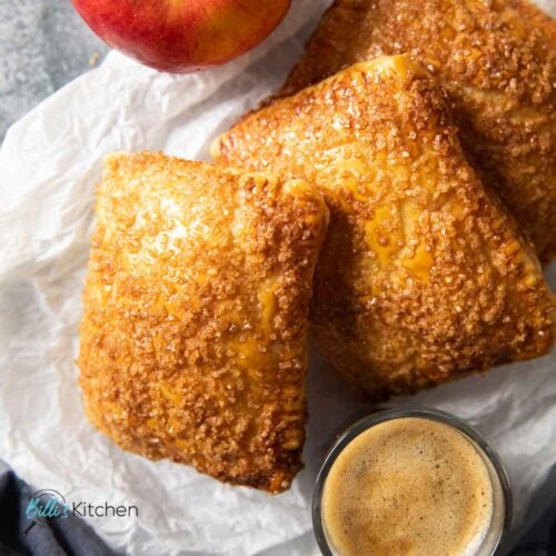 Feature image for Puff Pastry Apple Turnovers showing them served with a cup of espresso.