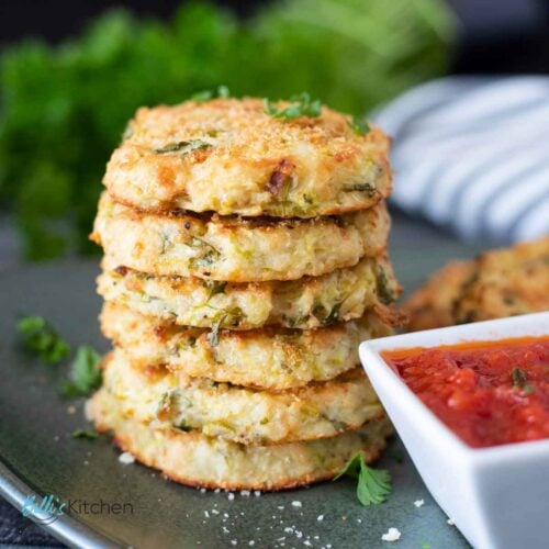 Feature image for Baked Zucchini Potato Bites, showing a stack of it, served with dipping sauce.