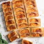 A fresh apple sheet cake, with some slces ready for serving.