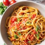 Feature image for Burst Cherry Tomato Pasta showing a serving of the dish.