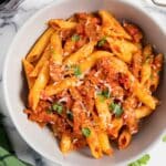 Feature image for easy chorizo pasta, showing the dish on a plate, with a bit of freshly grated cheese.