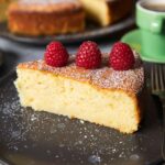 Feature image for Easy Lemon Ricotta Cake showing a slice of the soft cake.
