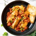 Feature image for one pan chicken with cherry tomatoes, served with some toasted bread.