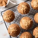 Freshly baked cinnamon muffins, cooling on a rack, ready for serving.