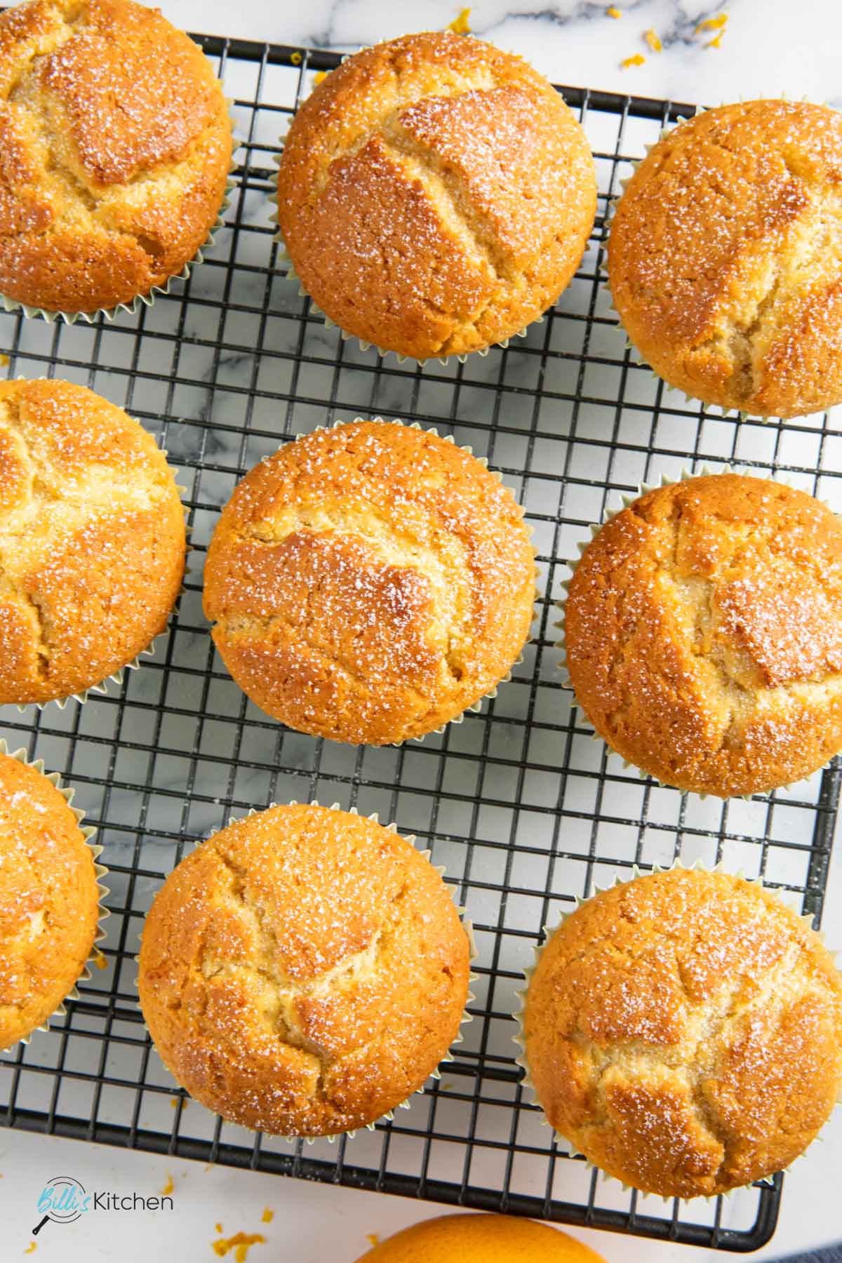 A closer shot of muffins with orange and yogurt, highlighting their golden color.
