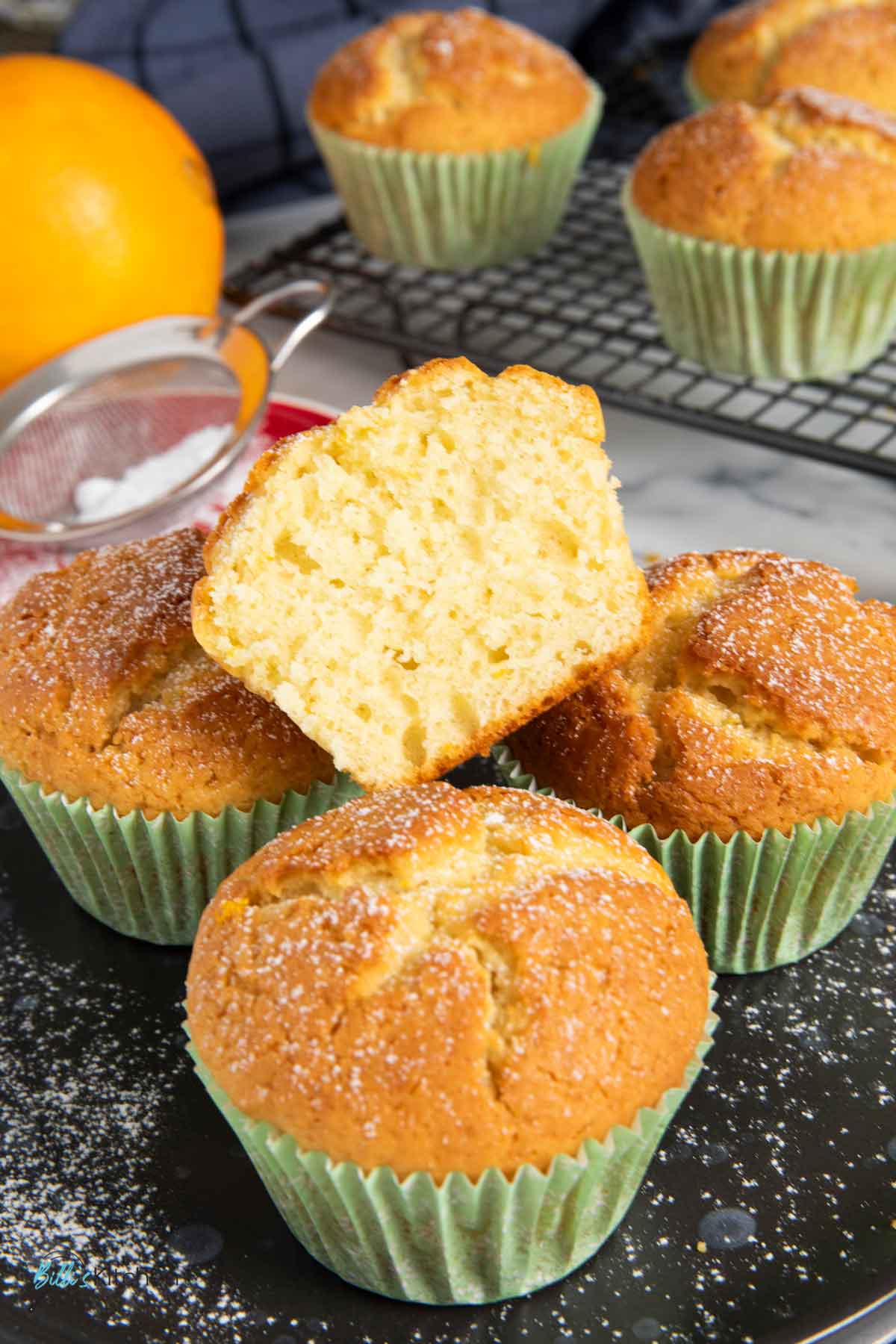 A half portion of orange yogurt muffin, showing the soft texture inside.
