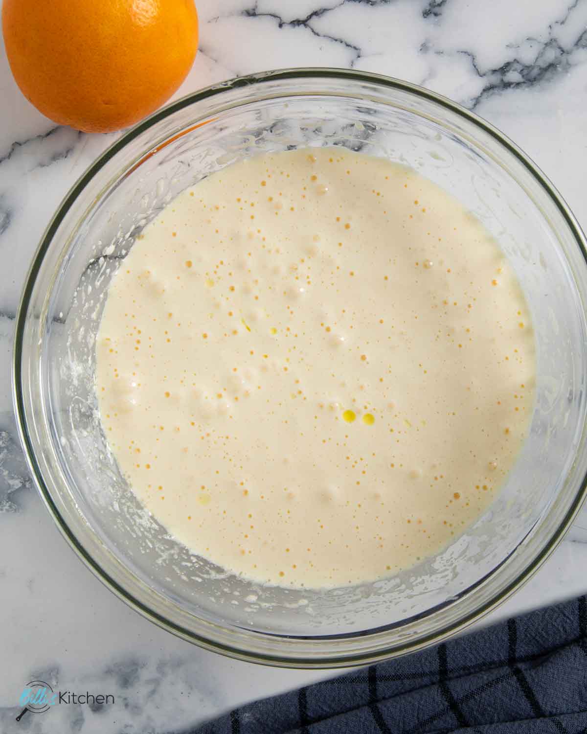 Adding oil and yogurt into the batter for orangee muffins.