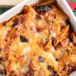 A closer shot of the top of baked eggplant and pasta, highlighting its golden color and the melted cheese.