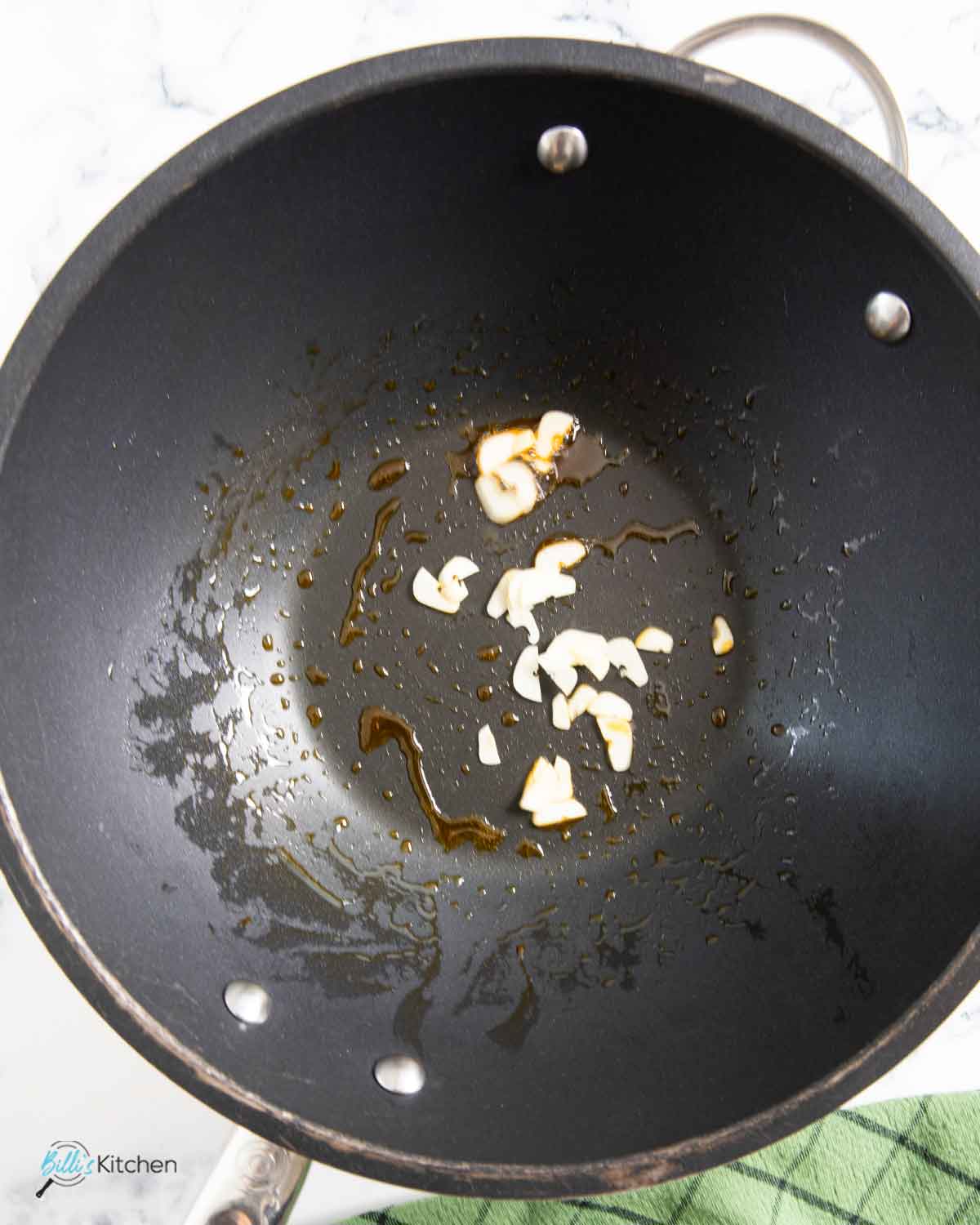 Using the oil from the kielbasa, cooking the garlic before the vegetables and the rice.