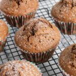 A closer shot of cocoa powder muffins, sprinkled with powdered sugar.
