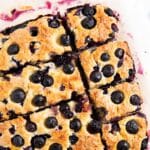 A closer shot of slices of yogurt breakfast cake with blueberries highlighting the golden color of the cake.