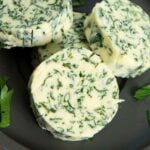 A closer shot of butter with parsley, highlighting the bits of herb inside.