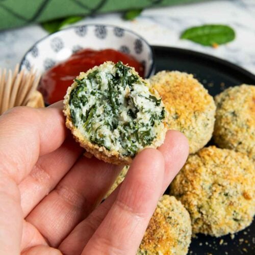 A closer shot of the inside of spinach and ricotta balls, highlighting its softness.