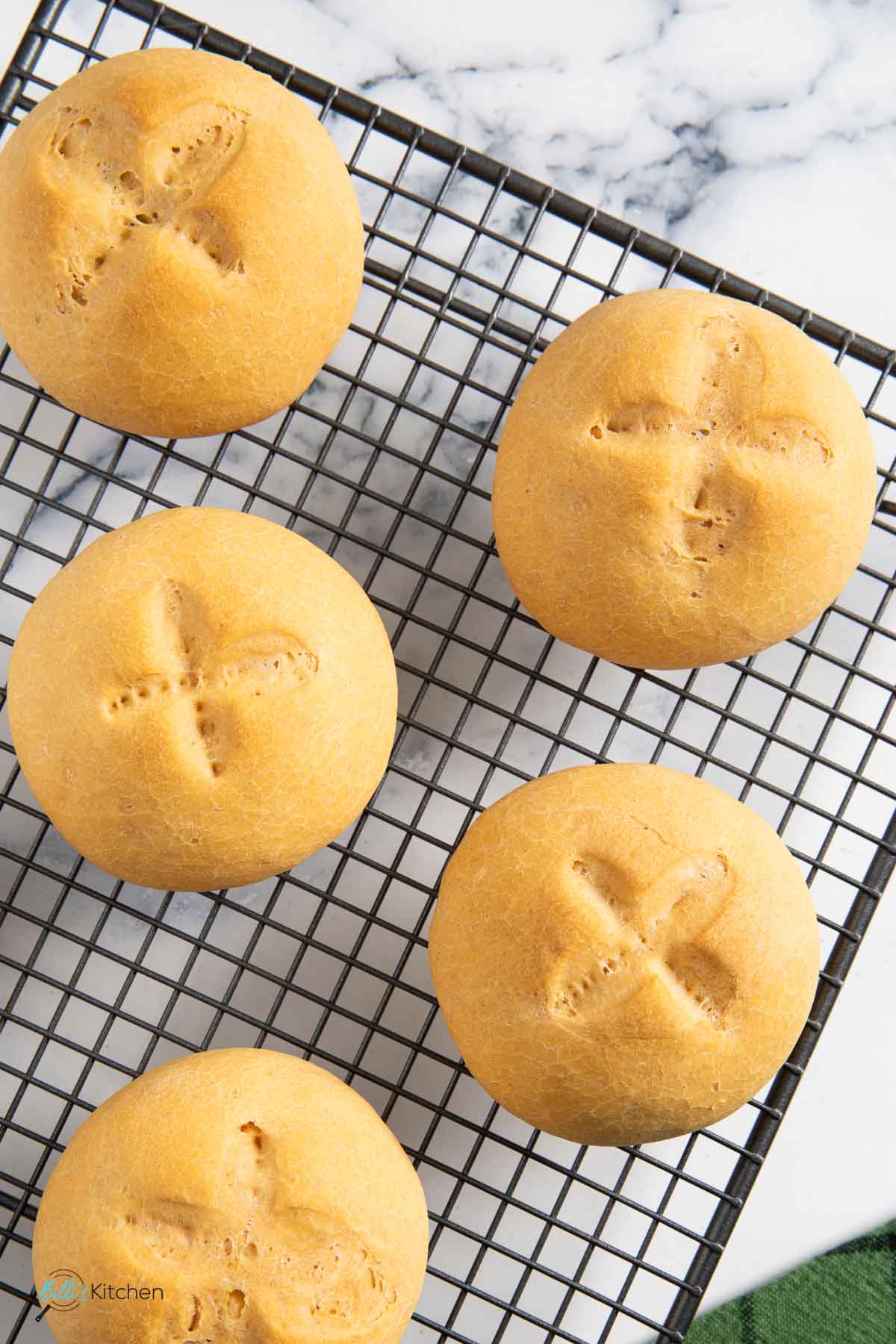 Freshly baked yogurt buns cooling on a rack.