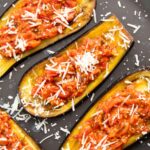 Roasted eggplants with tomatoes and cheese, ready for serving.
