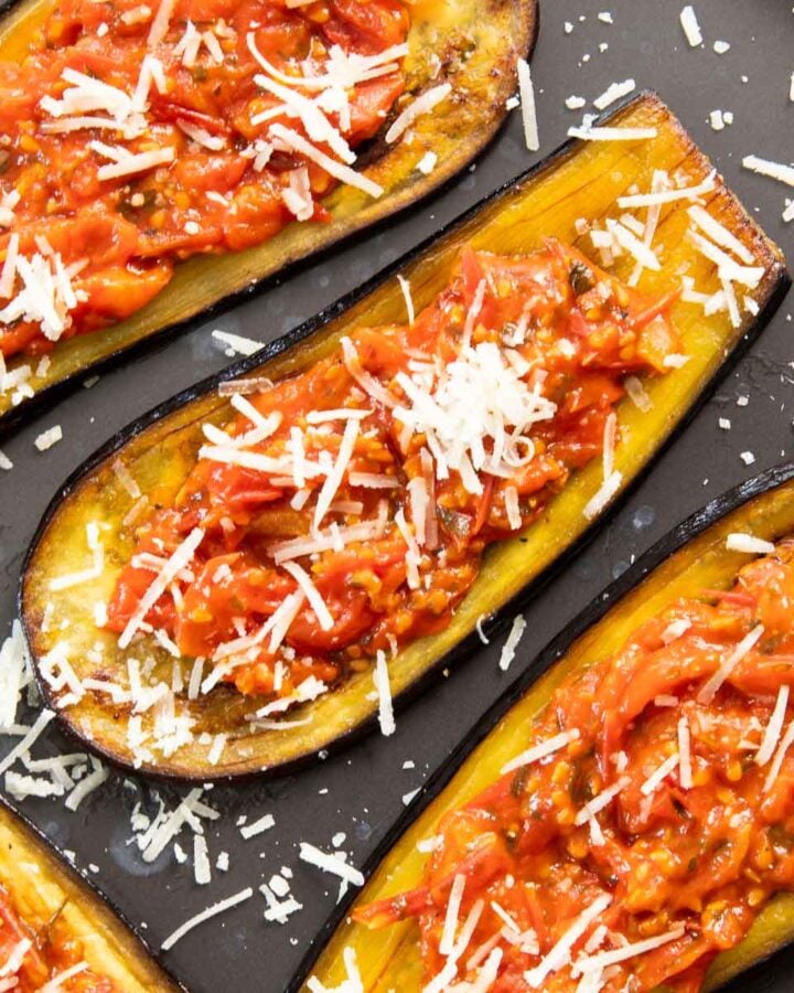 Roasted eggplants with tomatoes and cheese, ready for serving.