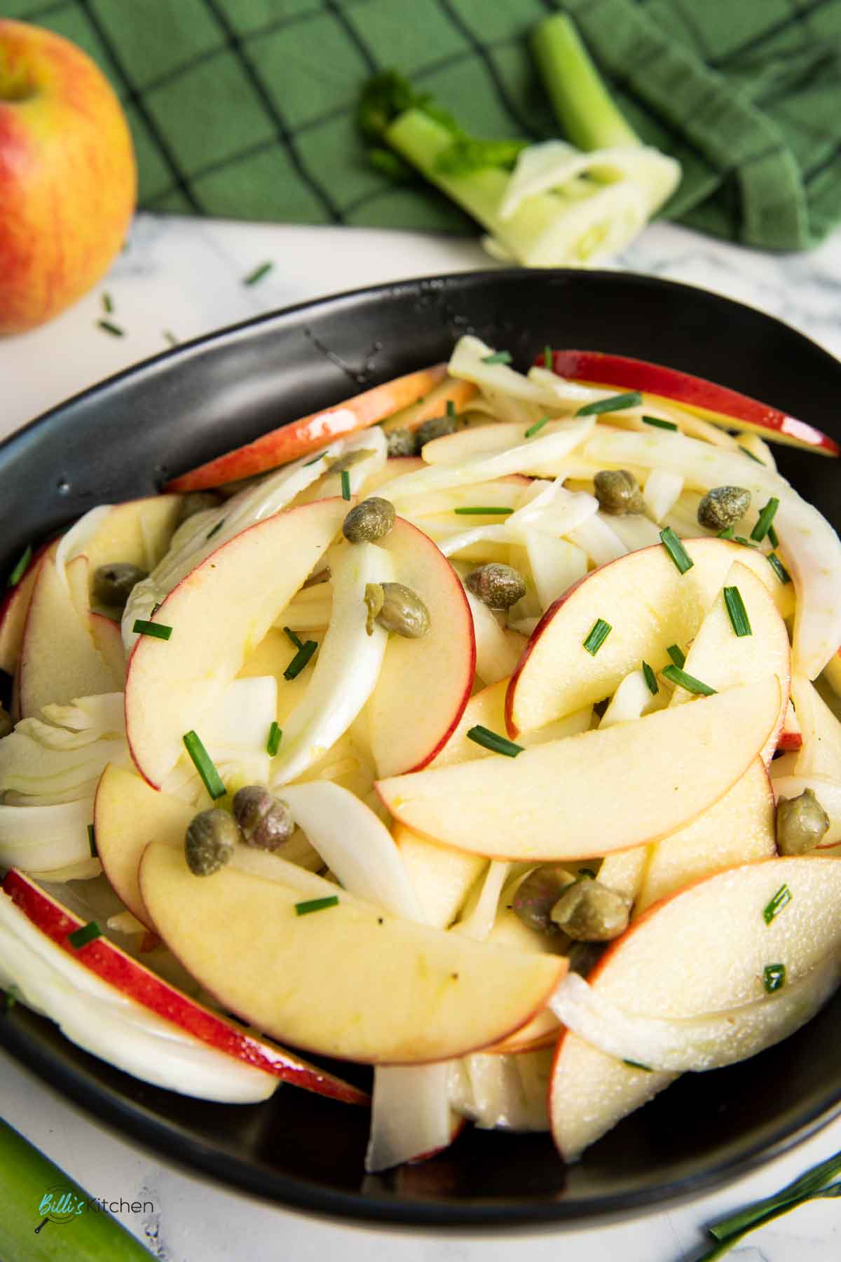 A closer shot of fennel salad with apples, highlighting the thinness of the apple slices.