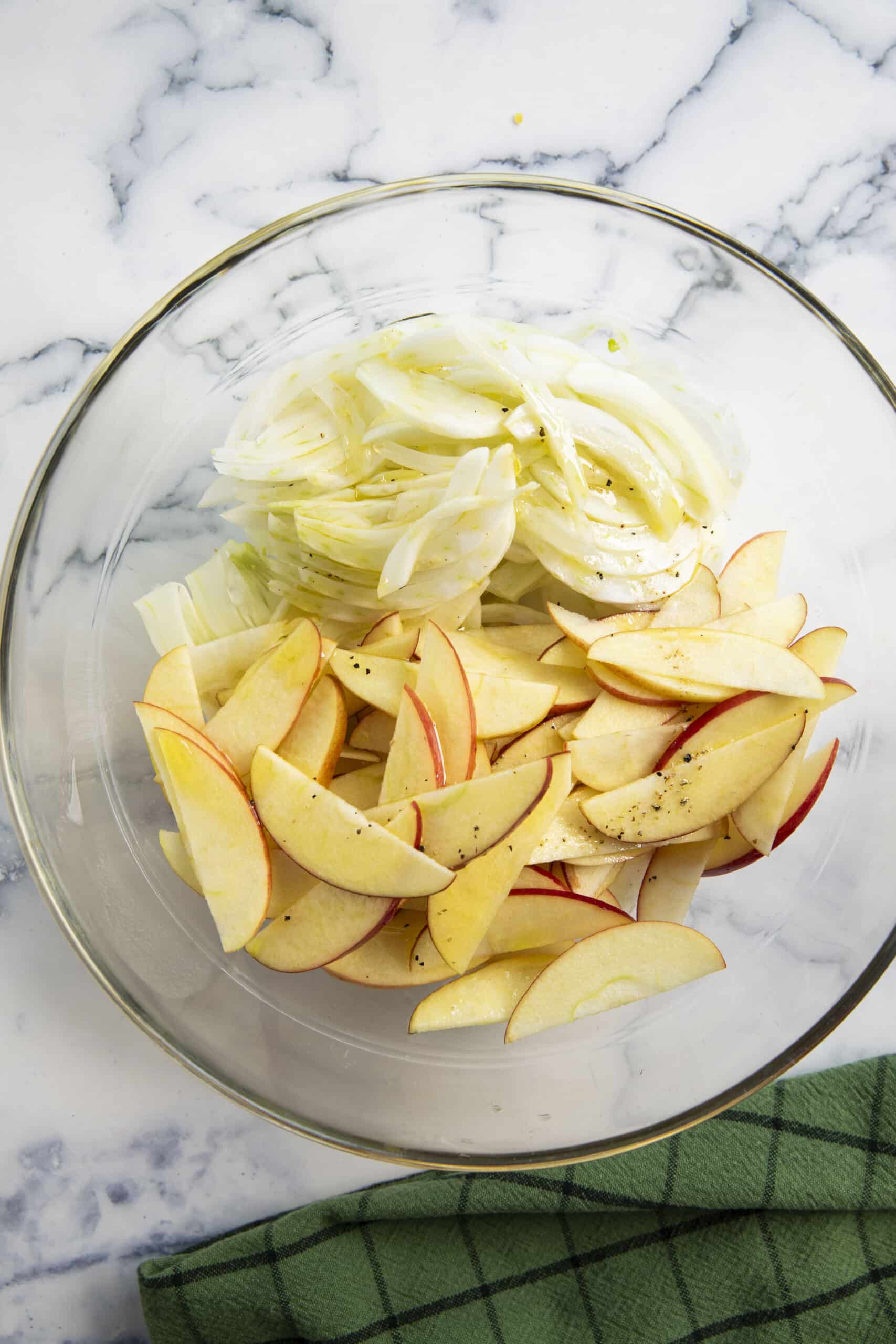 Thin slices of apples and fennel drizzled with the apple-cider and olive oil dressing.