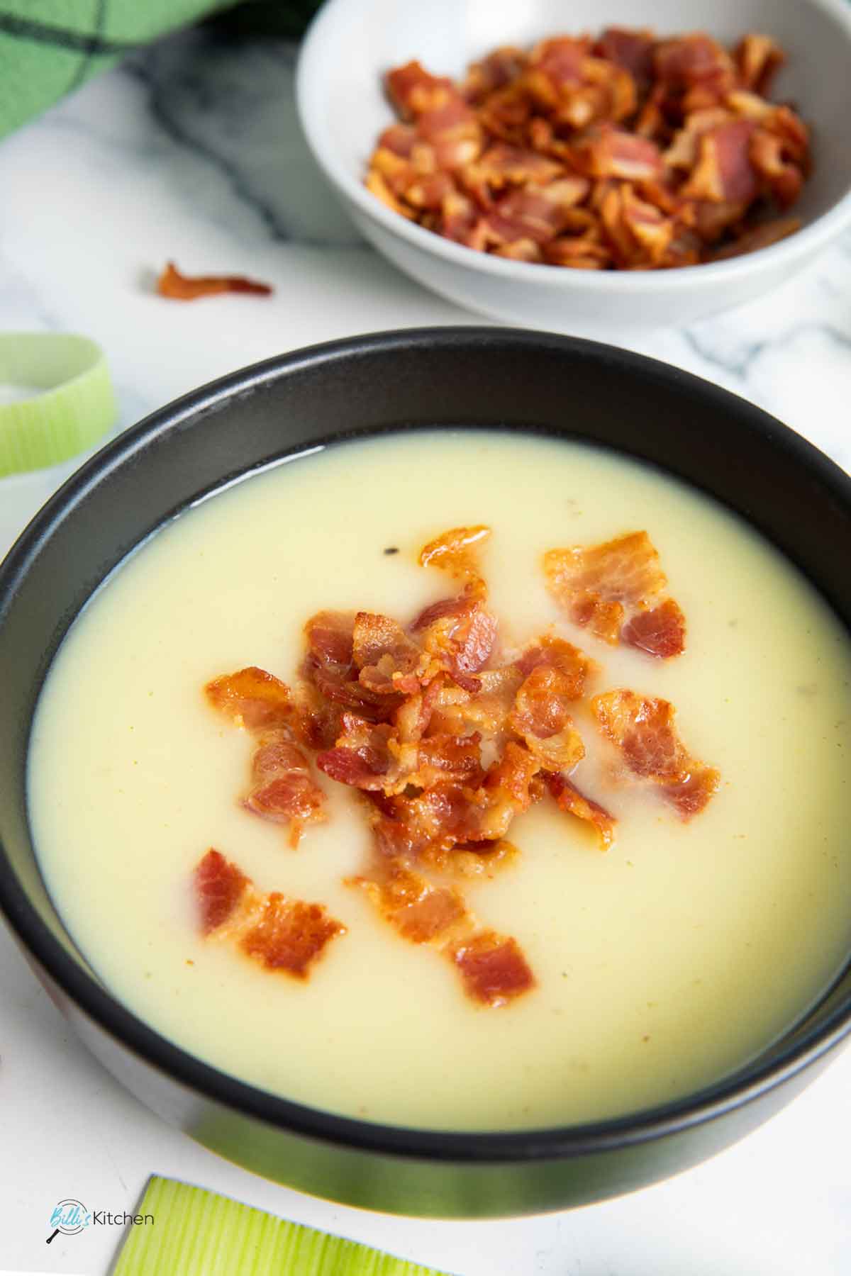 A closer shot of a bowl of soup made of leeks and potatoes, with no cream.