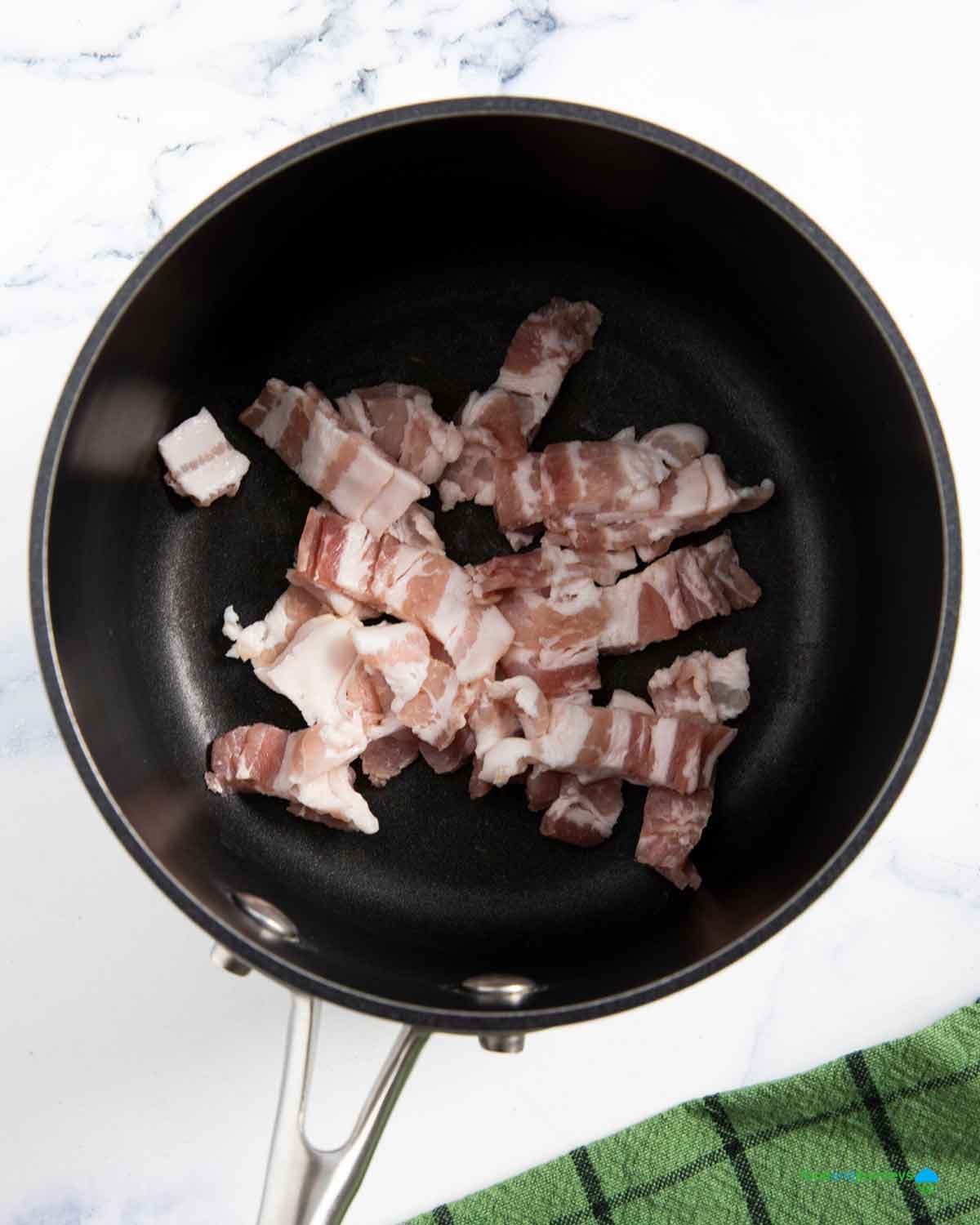 Frying the bacon and using its oil to sauté the garlic and onion, adds more flavor to the lentil soup.