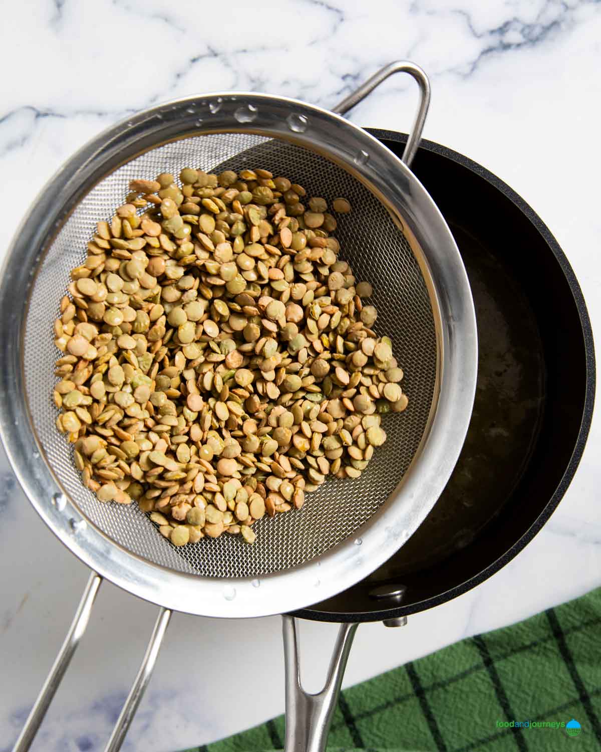 Rinsed and drained green lentils added to the boiling stock and left to simmer.